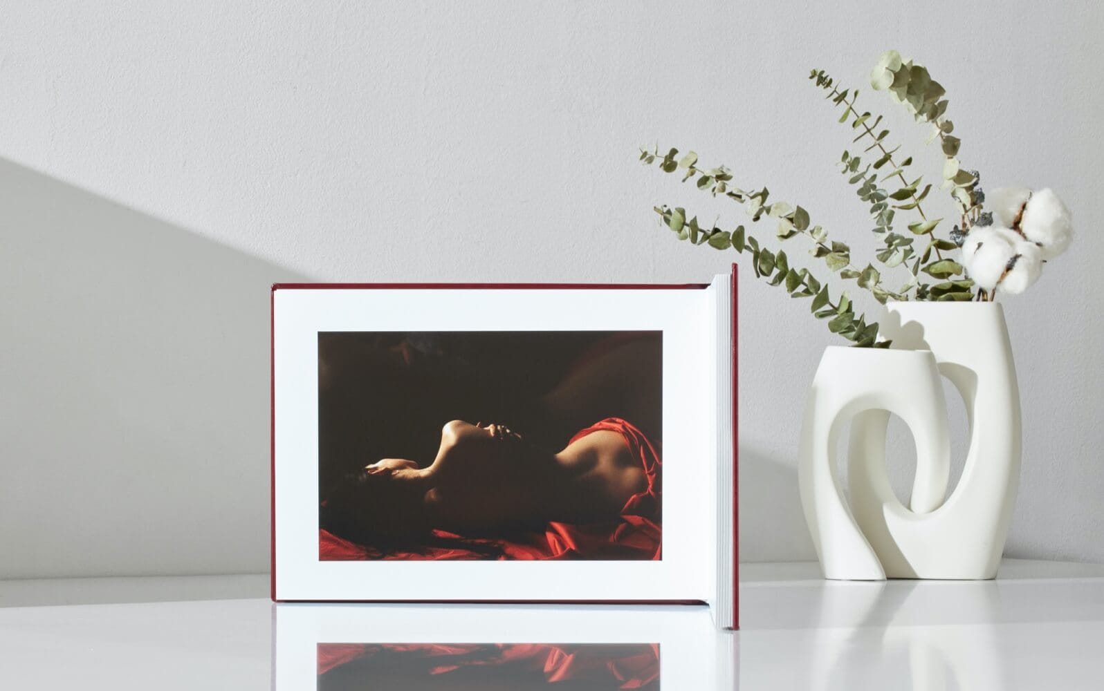 Open fine-art wedding album showing a full-spread bridal portrait on layflat pages