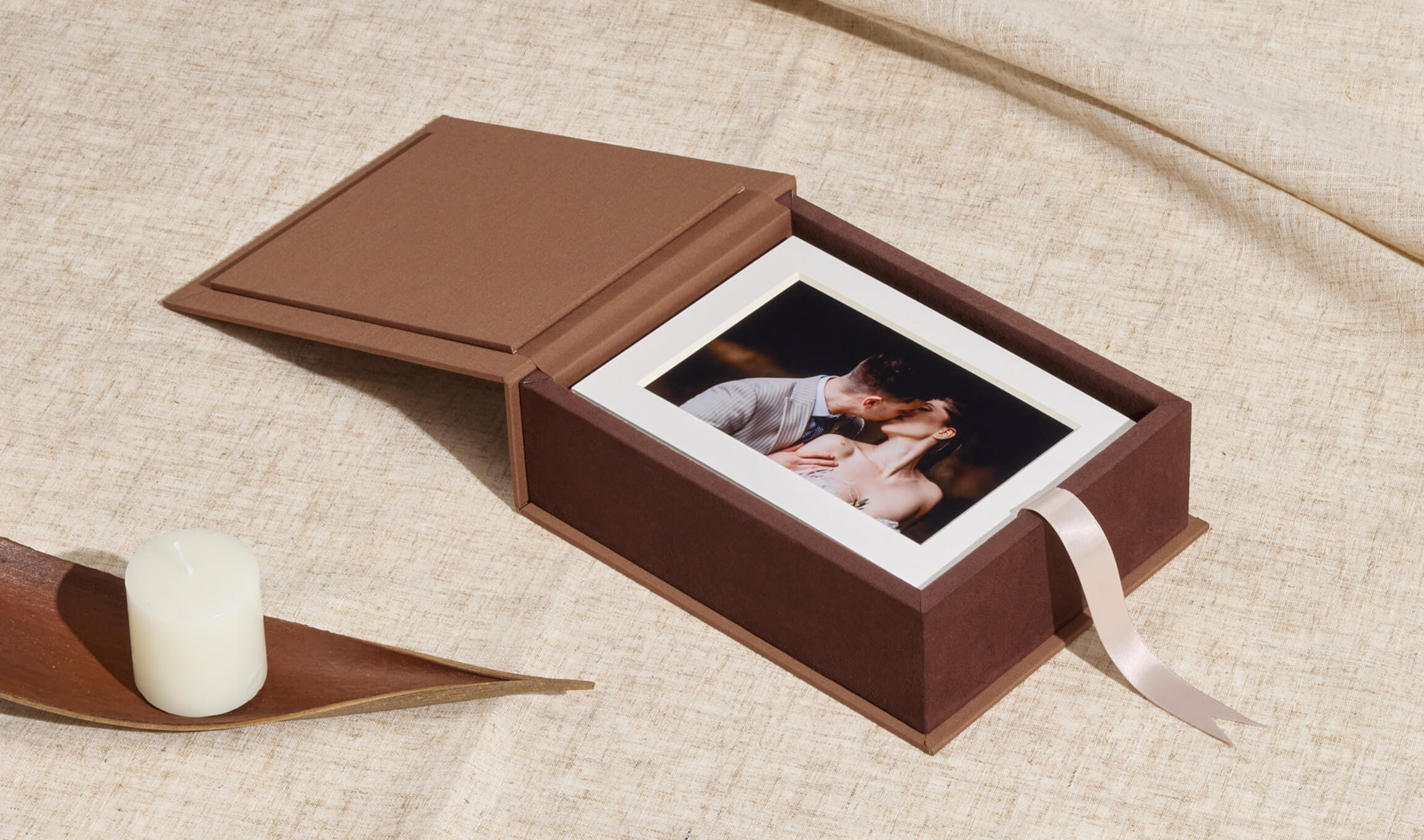 Linen folio box open, showing a set of matted fine-art wedding prints