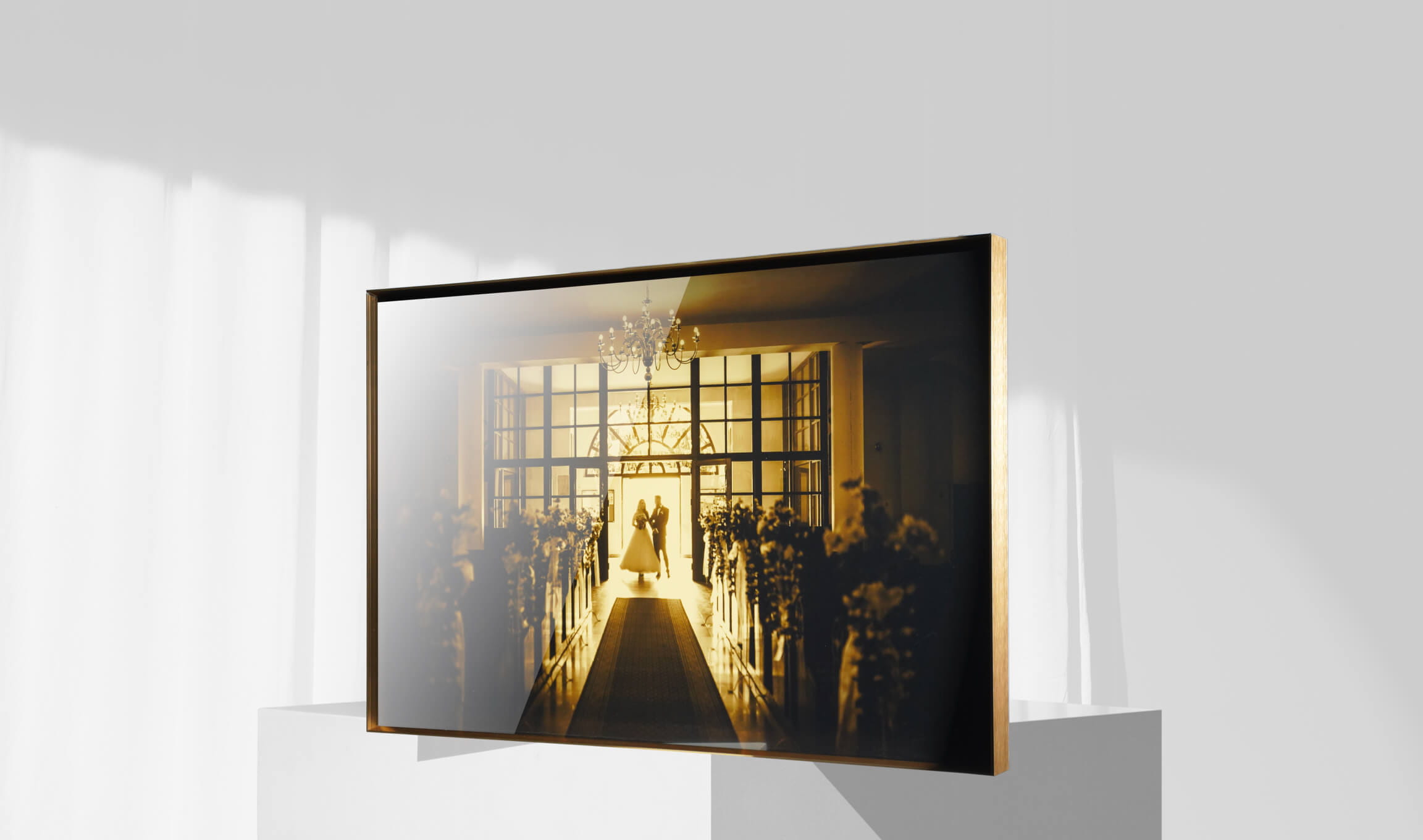 Framed fine-art wedding print on a wall with a hardwood frame and acid-free mat