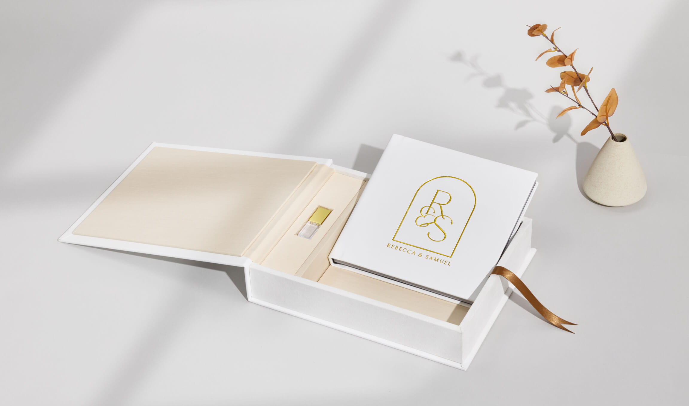 Presentation box with an engraved USB drive and wedding photographs