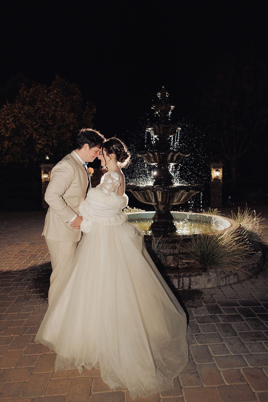 Evening wedding portrait by a lit fountain — Precious Pics Production